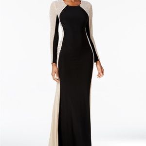 A long floor length gown with long beaded sleeves.
